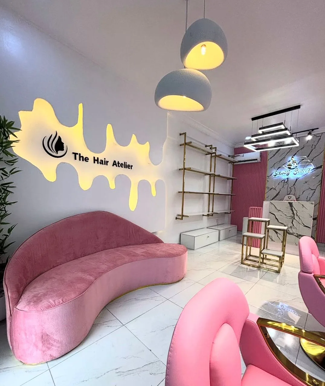 The Hair Atelier - Vibrant pink lounge and styling stations